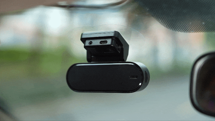 Connecting the power cable from the cigarette lighter to the DDPAI N5 Dual 4K dash cam after installation.