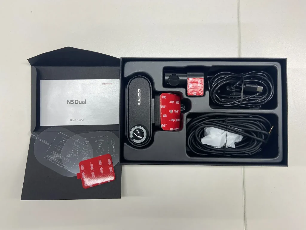 Open box of DDPAI N5 Dual 4K dash cam with user guide and accessories displayed.